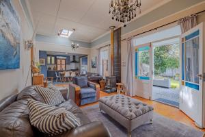 a living room with a couch and chairs and a living room at Blue Bell in Hermanus