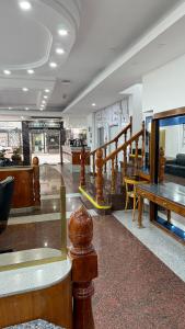 a lobby with a staircase and a table and chairs at Diplomat Hotel in Buenos Aires