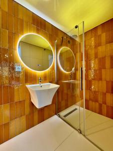 a bathroom with a sink and a glass shower at Greg Rooms in Sinaia