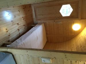 an inside view of a wooden sauna with a ceiling at Framtid Camping Lodging Barrels in Djúpivogur