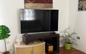 a flat screen tv sitting on top of a wooden entertainment center at ZenBreak The Tree House Apartment in Saint George +10 photos