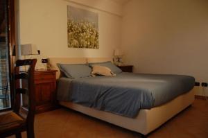 a bedroom with a bed and a dresser and a painting at Agriturismo Tenuta Lapone in Orvieto +37 photos