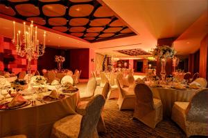 a banquet hall with white tables and chairs and a chandelier at Radisson Hotel Istanbul Merter in Istanbul +68 photos