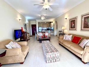 a living room with couches and a ceiling fan at ZenBreak Island Time at El Sol in Christ Church +9 photos