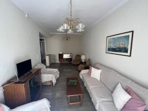 a living room with a couch and a tv at Marina's house in Preveza