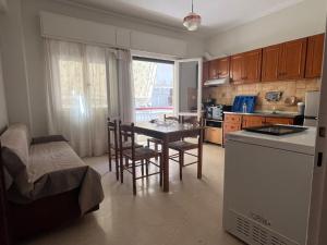 a kitchen with a table and chairs in a room at Marina's house in Preveza