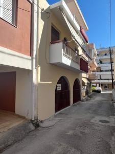 a building with a balcony on the side of a street at Marina's house in Preveza