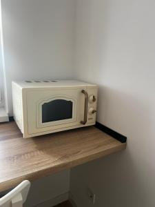 a microwave oven sitting on top of a shelf at AAS Vibe in Alba Iulia