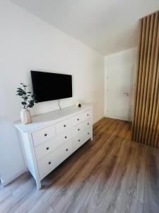 a white dresser with a flat screen tv on top of it at AAS Vibe in Alba Iulia +9 photos