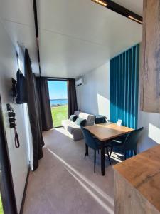 a kitchen and living room with a table and a refrigerator at Widoki Apartments Hel in Hel +74 photos