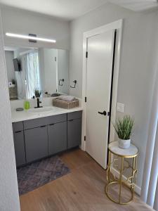a bathroom with a sink and a mirror at Costa Mesa Stay in Costa Mesa