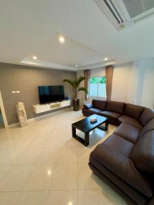 a living room with a couch and a coffee table at Meadows in Nong Prue +35 photos