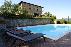a swimming pool with two lounge chairs next to a building at Palazzo Prugnoli, Monte Santa Maria Tiberina, 8 Bedroom villa with private pool & superb views in Perugia