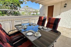 a table and chairs sitting on a patio at Fantastic vacation by the ocean in Playa de las Americas