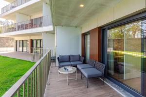 a balcony with two chairs and a table at Studio w/ Balcony, Pool & Gym in Antas by HostWise in Porto