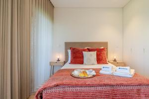 a bedroom with a bed with a tray of food on it at Studio w/ Balcony, Pool & Gym in Antas by HostWise in Porto