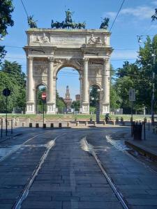 a large monument with an arch in the middle of a street at Allianz Mico Trade Fair nearby - ARENA SUITE ALL COMFORTS - citycentre outside of ZTL with FREE SECURE PARKING GARAGE - Free wi fi - subway Moscova GREEN LINE few minutes by walk in Milan