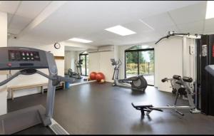 a gym with several treadmills and exercise machines at Quiet & Cozy Ski-In Out, Hot tub, pool in Whistler