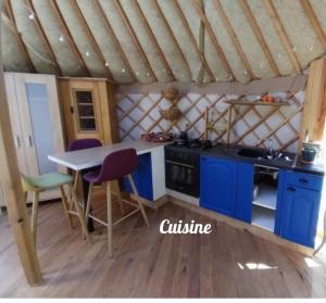 a kitchen in a yurt with a table and chairs at Yourte in Aouste-sur-Sye +6 photos