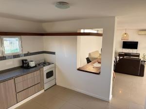 ネコチェアにあるDepartamento del marのコンロ付きのキッチン テーブルの横にあるトップオーブン +4枚の写真