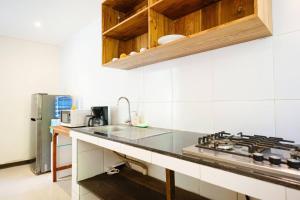 a kitchen with a sink and a stove at villa restu 2 in Ubud