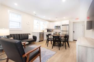 a living room with a couch and a table at Beautiful remodeled 3 bdr condo 200 ft from beach in Wildwood