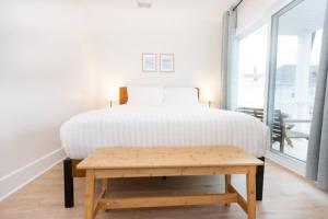 a bedroom with a bed and a wooden table at 3 BDR Renovated Condo The Beach1 block in Wildwood