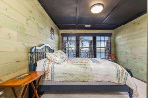 a bedroom with a bed and a wooden wall at Gilead Grand Lake Family Retreat in Grove +50 photos
