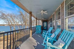a porch with blue chairs on a house at Gilead Grand Lake Family Retreat in Grove