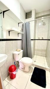 a white bathroom with a toilet and a sink at Aqui y Ahora in Pisac