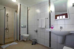 a bathroom with a sink and a toilet at Aquarius Hotel in Side