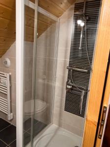 een douche met een glazen deur in een badkamer bij NEW Chalet Le Sabot 12p - Sauna - 90m telecabine in Oz +47 foto's