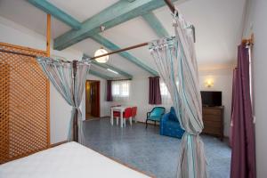 a bedroom with a bed and a table and chairs at Aquarius Hotel in Side