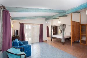 a living room with a bed and a blue couch at Aquarius Hotel in Side +100 photos