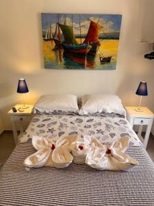 a bedroom with a bed with two towels on it at Pipa Magnólia Suite in Pipa +34 photos