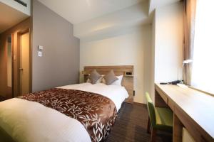 En eller flere senge i et værelse på Hotel Sunshine Utsunomiya