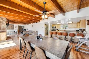 a dining room and kitchen with a wooden table and chairs at Mt Doble Dream Home #504 in Big Bear City