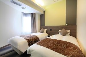 Postel nebo postele na pokoji v ubytování Hotel Sunshine Utsunomiya