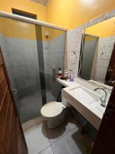 a bathroom with a toilet and a sink and a shower at Casa in Ananindeua