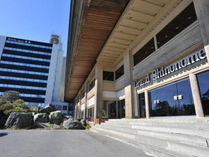 a large building with a sign on the side of it at ホテルグランド東雲 in Tsukuba