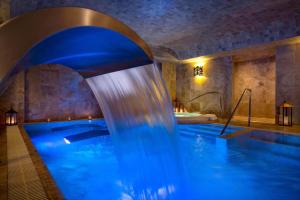 a swimming pool in a hotel room with a tub at Palacio del Inka, a Luxury Collection Hotel, Cusco in Cusco