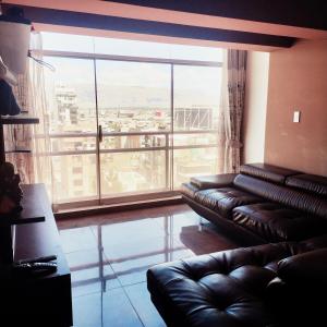 a living room with a couch and a large window at Casa Hogar Andina Huancayo - San Carlos 3 in Huancayo +12 photos