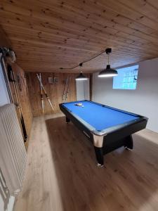a pool table in a room with a ceiling at Ferienhaus am Bach in Medebach