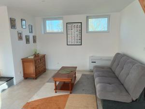 a living room with a couch and a table at la ferme du renard et son gîte 
