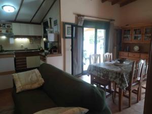 a living room with a couch and a table and a kitchen at Casa Atalaya in Corme-Puerto