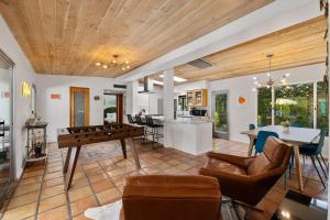 a living room with a ping pong table at The Ricardo! Mid-Century Villa with Saltwater Pool in Palm Springs