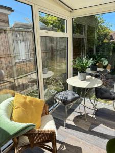 a screened in porch with a table and chairs at Amazing City Centre Home in Derby