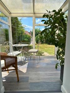 a screened in porch with a table and chairs at Amazing City Centre Home in Derby