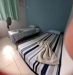 Ένα ή περισσότερα κρεβάτια σε δωμάτιο στο Meu conforto +5 φωτογραφίες