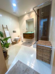 a bathroom with a shower and a sink and a toilet at Casa Custodio in Olhão